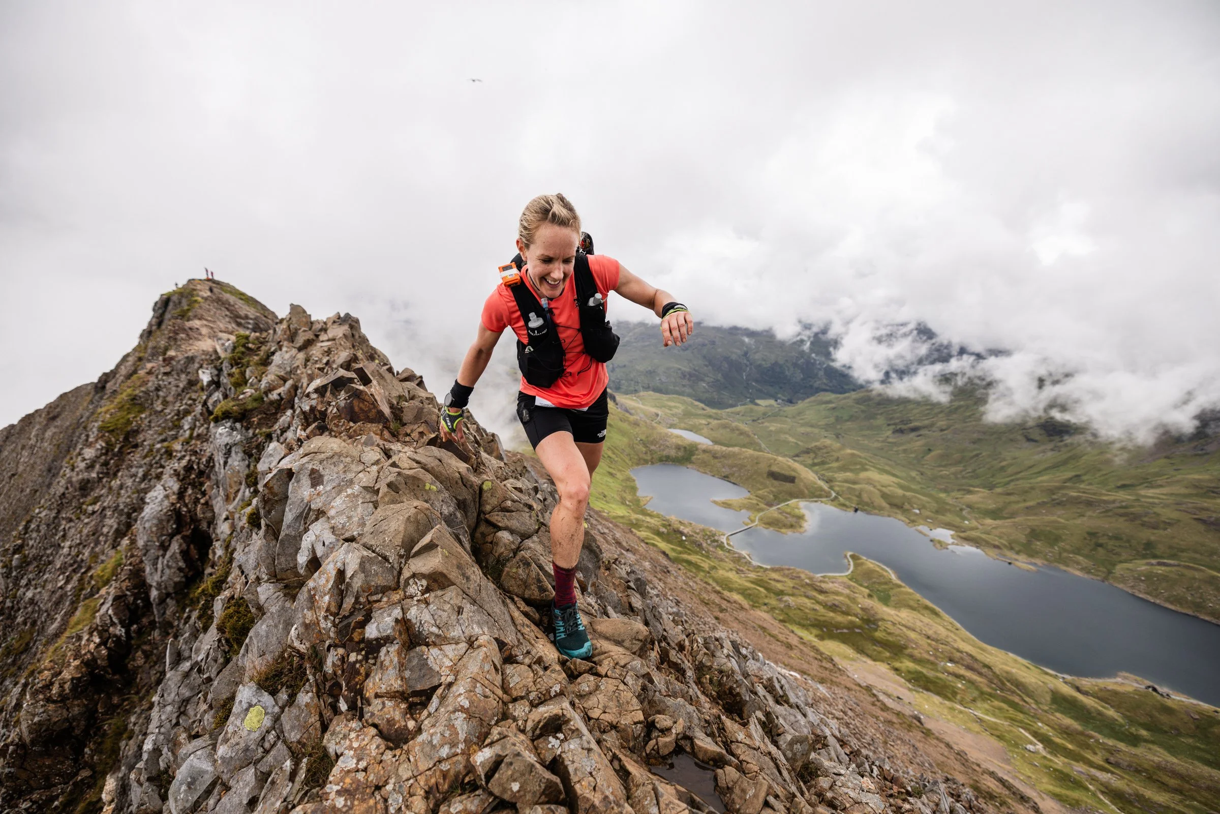 Runner moving along an exposed mountain ridge