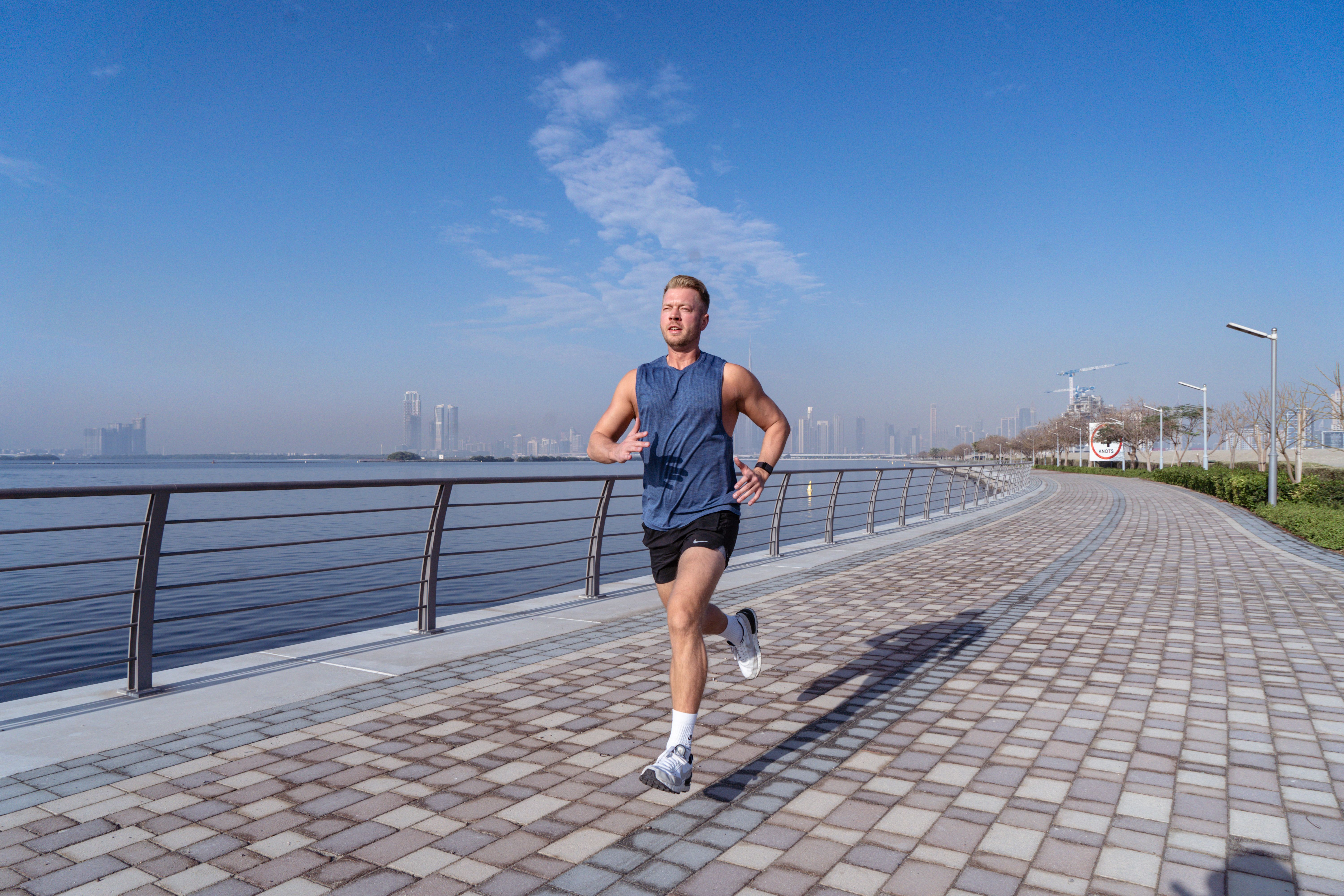 Runner training on a waterfront path